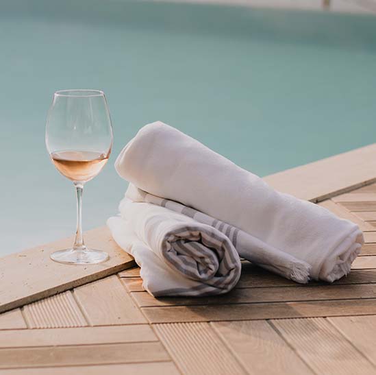 Towels and Wineglass at Swimming Pool Towels and Wineglass at Swimming Pool